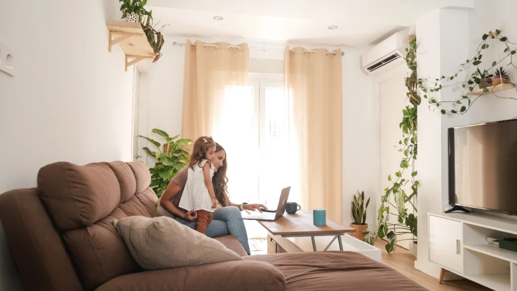 mother and child sitting together on a couch in a cozy living room